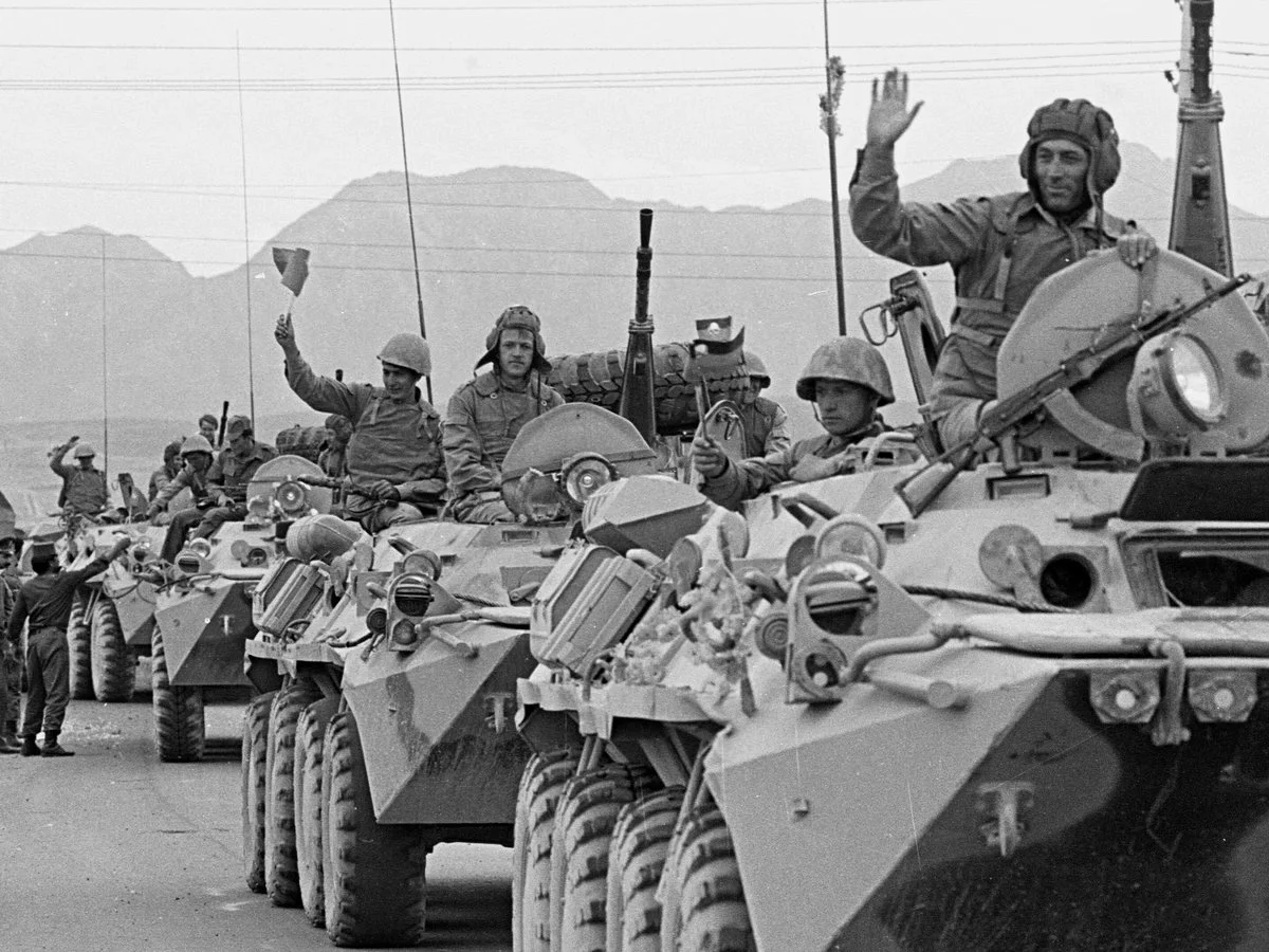 A convoy of Soviet tanks wave to crowds after their arrival in Kabul from the eastern city of Jalalabad as part of the Soviet withdrawal from Afghanistan, May 1988. [Reuters]