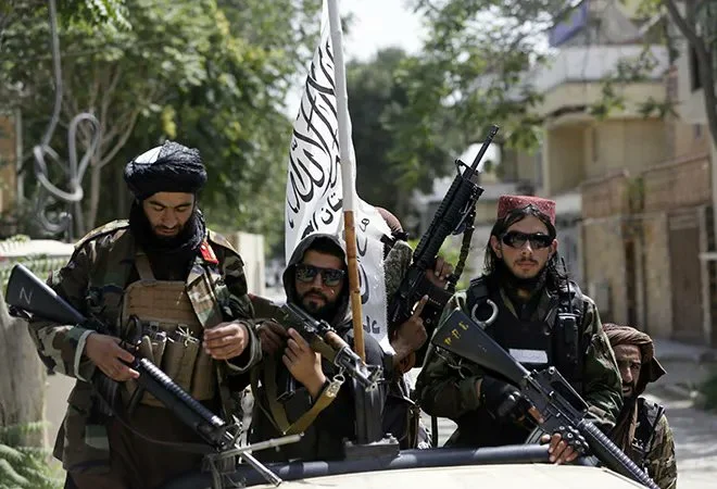 IEA fighters display their flag on patrol in Kabul, Afghanistan [AP]