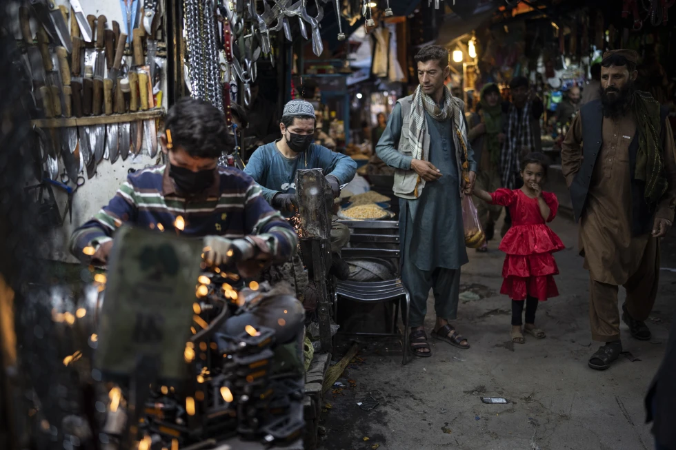 Afghanistan's economy shows modest signs of growth, but trade deficits and restrictions on women's education pose serious challenges. [Image via AP News]