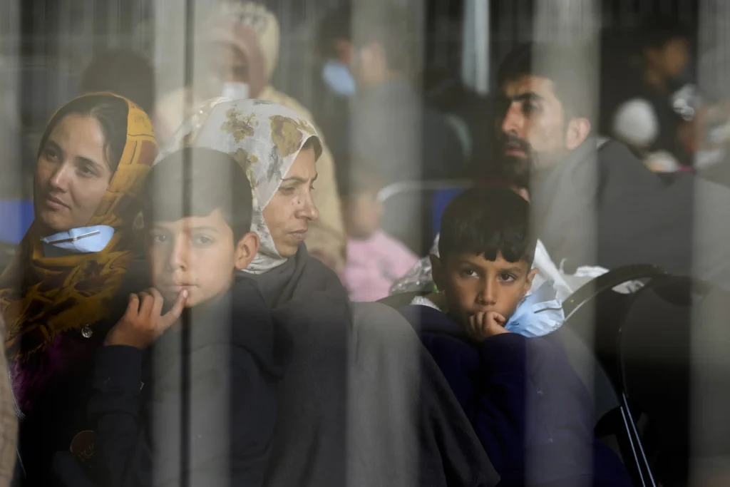 Evacuees from Afghanistan wait to fly to the US or another safe location in a makeshift departure gate inside a hangar at the US airbase in Ramstein, Germany, on 1 September 2021. [AP]