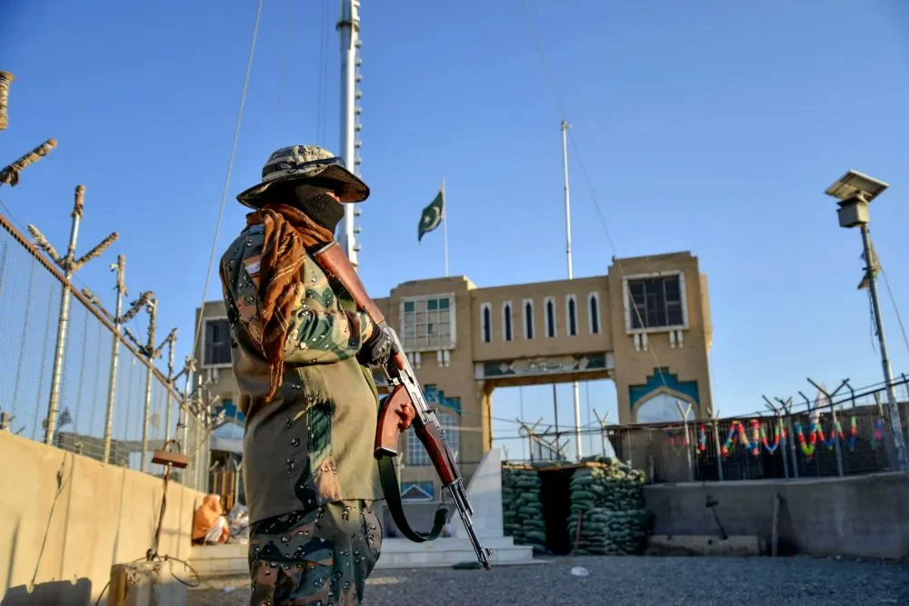 An Afghan security personnel stands guard at a fenced corridor of the Afghanistan-Pakistan border in Spin Boldak district, Kandahar province on December 3, 2023. [AFP/File]